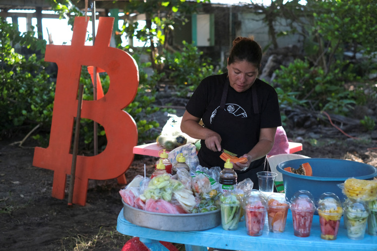 A woman sells fruit in a market during a Bitcoin summit, in Chiltiupan, El Salvador