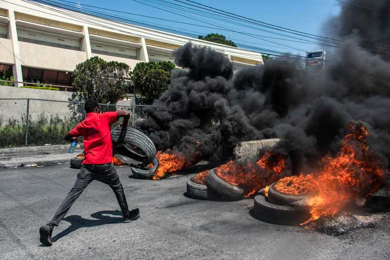 A protester burns tires during a demonstration