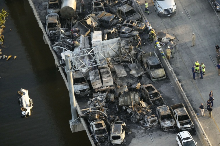 Responders are seen near wreckage in the aftermath of a multi-vehicle pileup on Interstate 55 in Manchac, La.