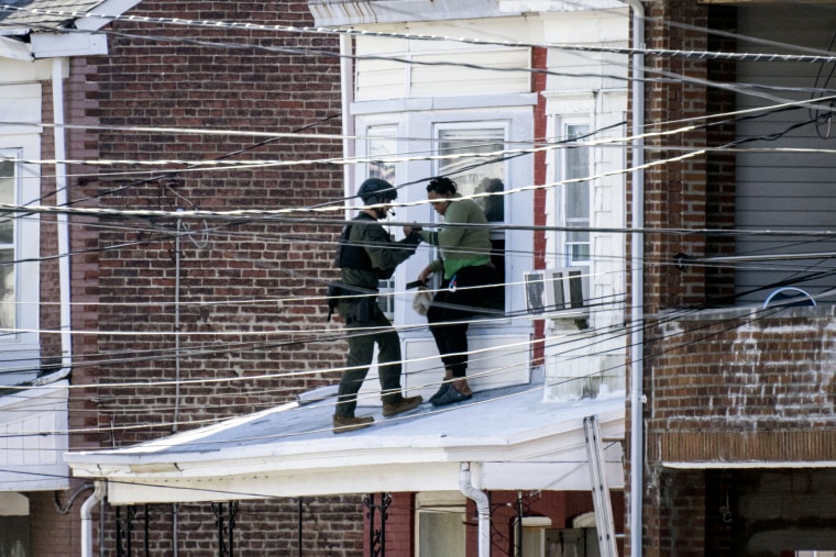 Police remove people from a home in Trenton New Jersey.