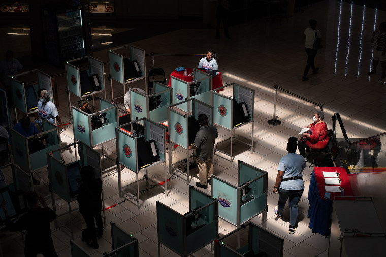 Election workers help as people vote at a polling place in Las Vegas on June 14, 2022.