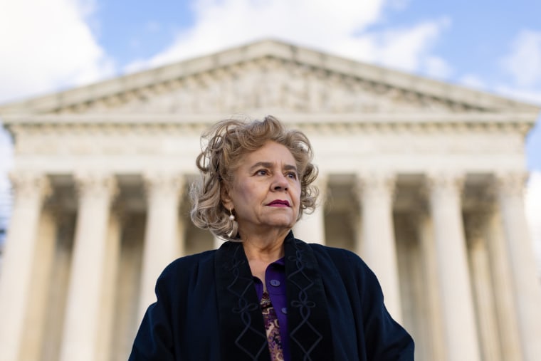 Sylvia Gonzalez stands in front of the Supreme Court building