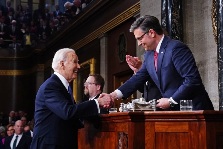 President Joe Biden shakes hands with House Speaker Mike Johnson during the State of the Union address at the Capitol on March 7, 2024. 