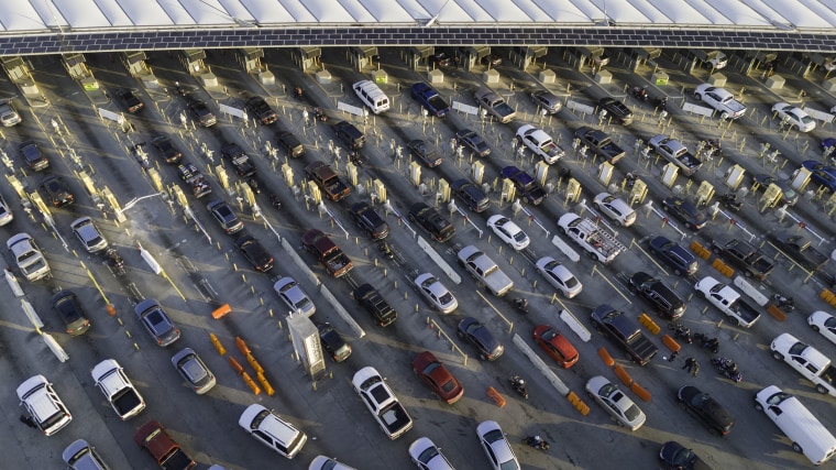  In an aerial view, morning commuter traffic waits to cross into the United States from Tijuana, Mexico on March 6, 2024 in San Ysidro, California. 