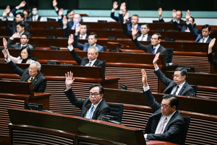 Lawmakers vote for Article 23 in the chamber of the Legislative Council