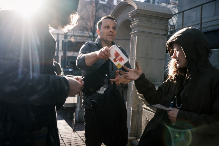 Ricco Mejia passes out Narcan to a group of people in downtown Portland