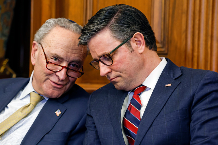 Chuck Schumer talks to Mike Johnson at the Capitol.