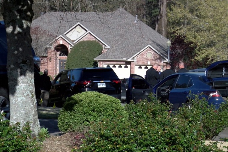 A screenshot of law enforcement officials and vehicles outside a home in west Little Rock, Ark.,