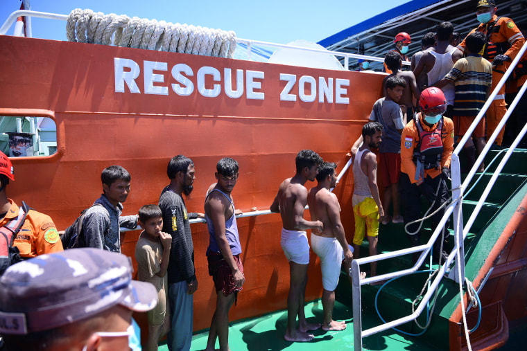 Rohingya refugees board a National Search and Rescue Agency vessel after they were rescued from their capsized boat in waters some 16 nautical miles off west Aceh on March 21, 2024. 