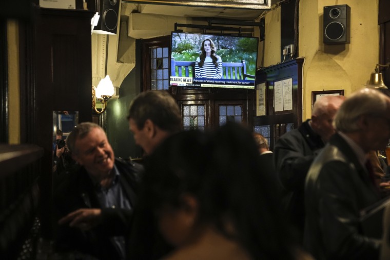 People watch a broadcast of an announcement by the Princess of Wales, in the Westminster Arms public house in Westminster, London,