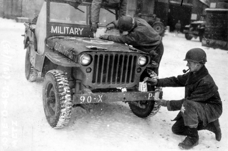 This photo provided by the Ghost Army Legacy Project shows a Jeep getting new bumper markings for special effects For decades, their mission during World War II was a secret. 