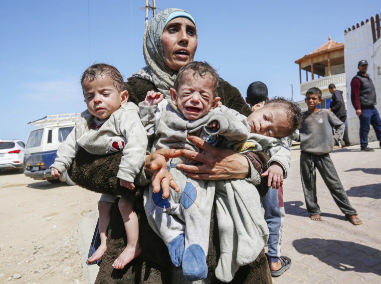 Palestinian woman Nuzha and her triplets forced to move south after Israeli attacks