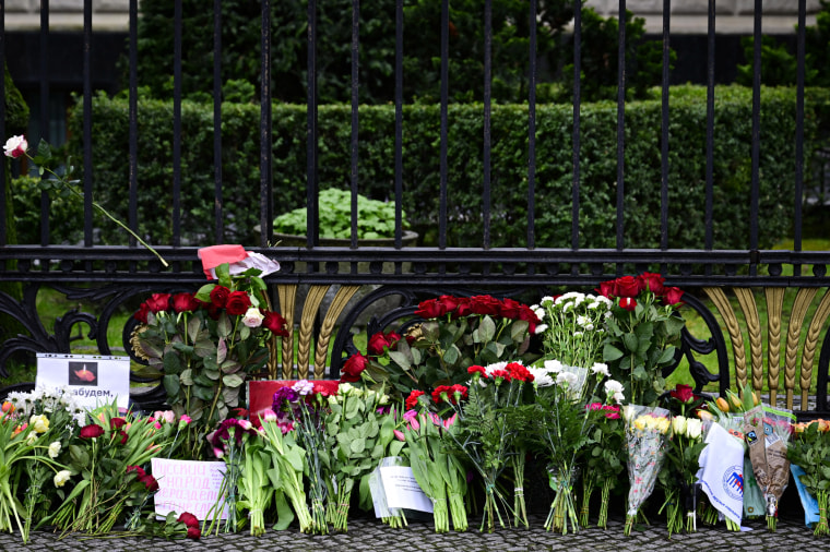 Flowers and placards lay at a makeshift memorial outside the Russian embassy in Berlin.