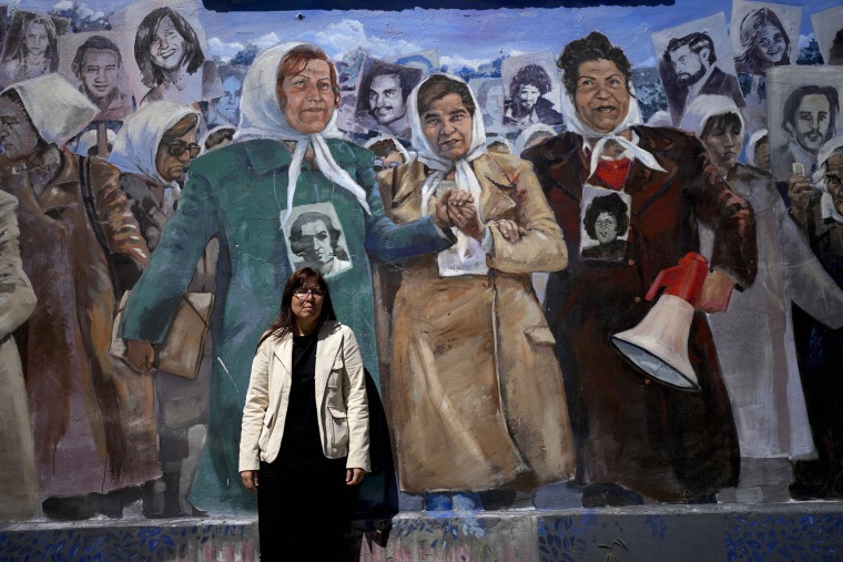 Claudia Poblete in front of a mural depicting the Mothers of Plaza de Mayo group, at the former Navy School of Mechanics, known as ESMA, now a human rights museum, in Buenos Aires.
