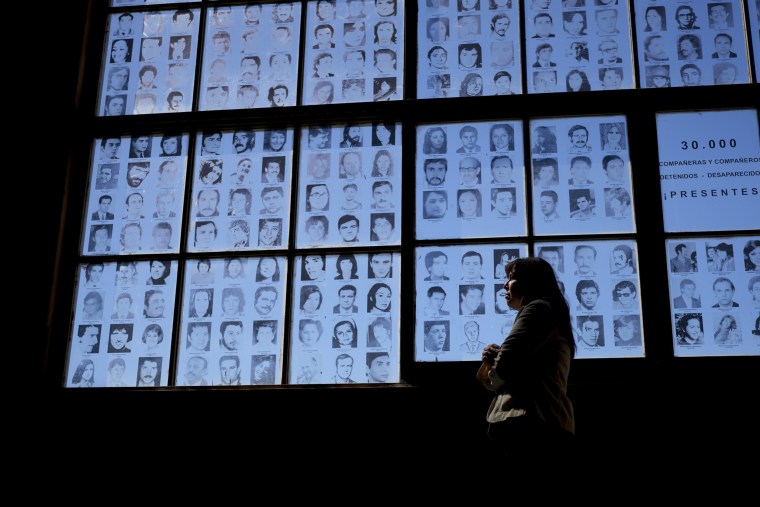 Claudia Poblete in front of a display of photographs of people disappeared during Argentina's military dictatorship at the Museum of Space for Memory and the Promotion and Defense of Human Rights, in Buenos Aires