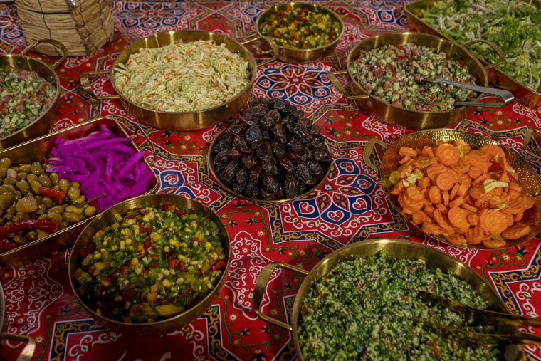 A detail shot of the table with dishes around a plate of dates.