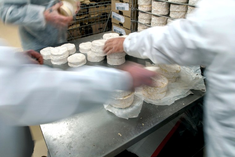 Camembert cheeses are packed into boxes at the Isigny Sainte