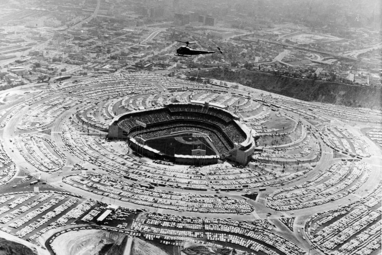 A helicopter hovers over Dodger Stadium on Opening Day of the baseball season