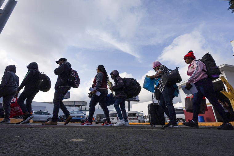 People, including many Haitians, leave Mexico to cross into the United States