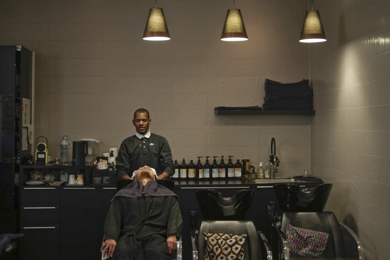 A customer has his hair shampooed at a salon in Paris, Wednesday, March 27, 2024. 