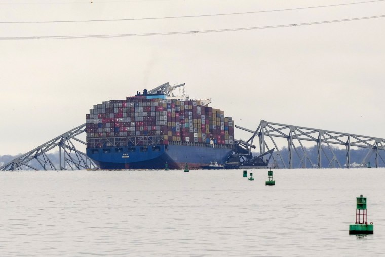 A container ship rests against wreckage of the Francis Scott Key Bridge in Baltimore, Md.