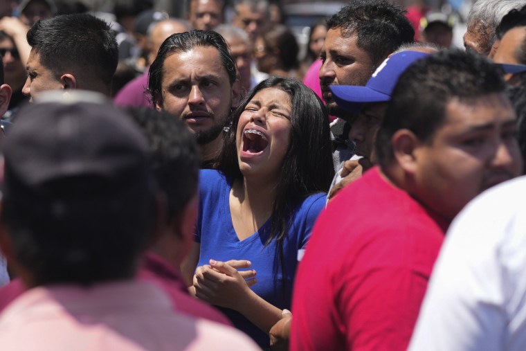 A relative of an 8-year-old girl, who was kidnapped the previous day, weeps as her body is handed over to family in Taxco, Mexico, Thursday, March 28, 2024. 