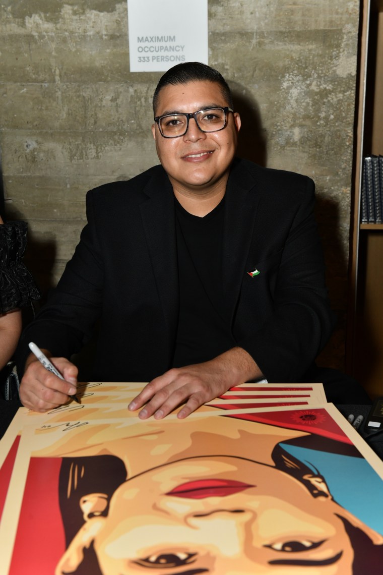 Artist Ernesto Yerena with his painting of America Ferrera for the event.