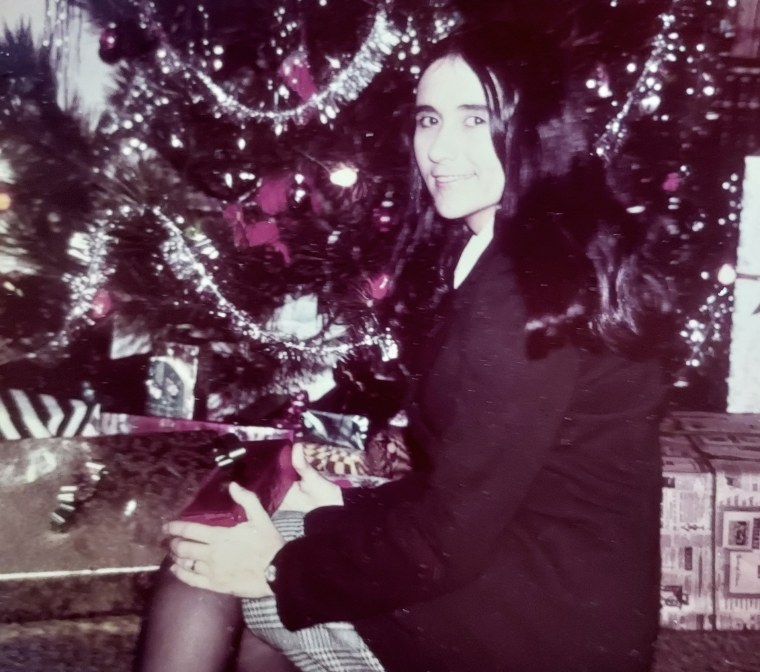Ann Kline sitting by her Christmas tree
