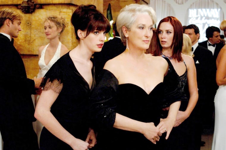  Anne Hathaway, Meryl Streep, Emily Blunt in black gowns in a scene from "Devil Wears Prada"