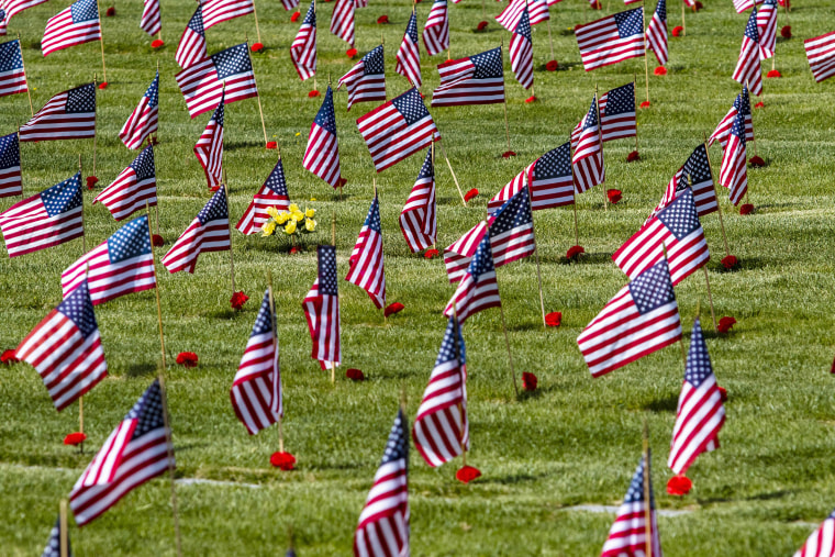 American flags and flowers seen at a veterans cemetery
