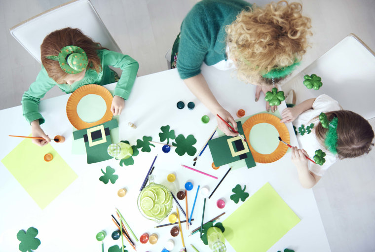 Family preparing decorations for Saint Patrick's Day.