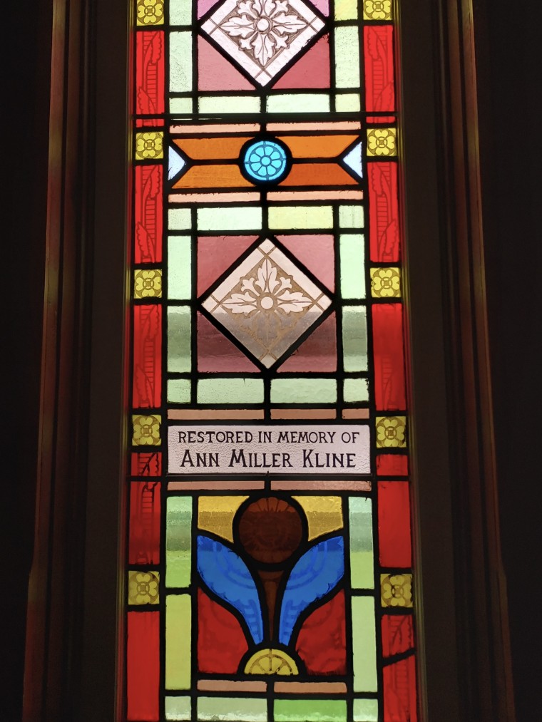 Ann Kline's name engraved on a stained glass window inside the Miller family's church