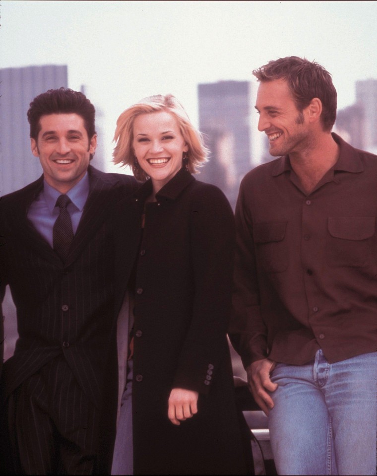 Dempsey, Witherspoon and Lucas stand smiling against the NYC skyline.