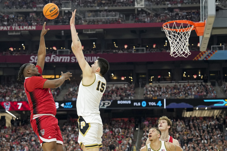 North Carolina State forward DJ Burns Jr. #30 shoots over Purdue center Zach Edey #15 during the first half of the NCAA college basketball game at the Final Four in Glendale, Ariz., on Saturday, April 6, 2024