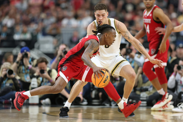 DJ Horne #0 of the North Carolina State Wolfpack dribbles the ball while being guarded by Mason Gillis #0 of the Purdue Boilermakers in the first half in the NCAA Men's Basketball Tournament Final Four semifinal game at State Farm Stadium on April 06, 2024 in Glendale, Arizona.
