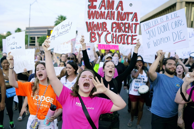 Protesters in Phoenix march around the Arizona state Capitol after the U.S. Supreme Court decision to overturn the landmark Roe v. Wade abortion decision on June 24, 2022.