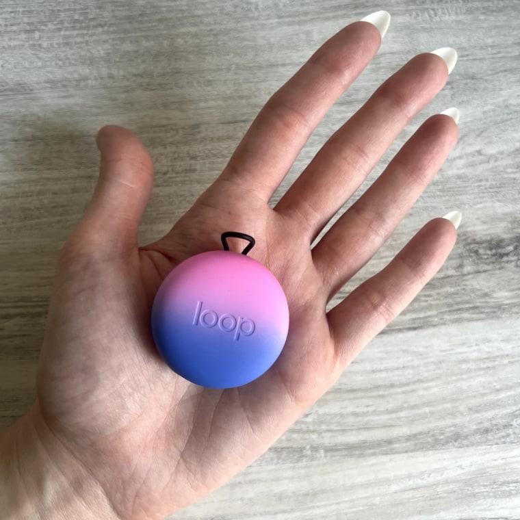 Picture of a hand holding a Loop Quiet earplugs case on the palm.