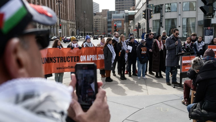 Demonstrators stand around a speaker in Milwaukee