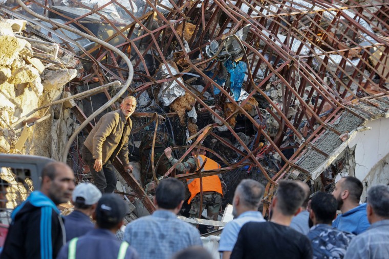  Emergency and security personnel inspect the rubble at the site of strikes which hit a building next to the Iranian embassy in Syria's capital Damascus, on April 1, 2024. 