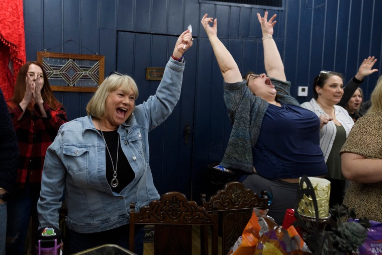 Member of Enid Social Justice Committee Connie Vickers and Leslie Terrell cheer