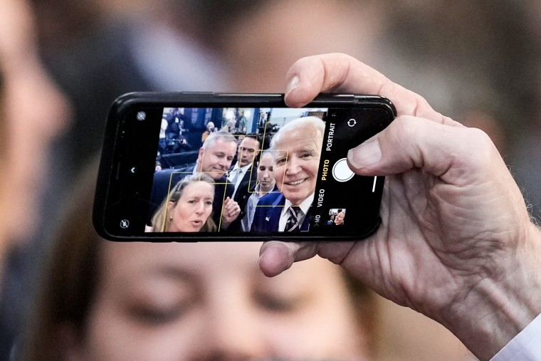 President Joe Biden takes a selfie with people