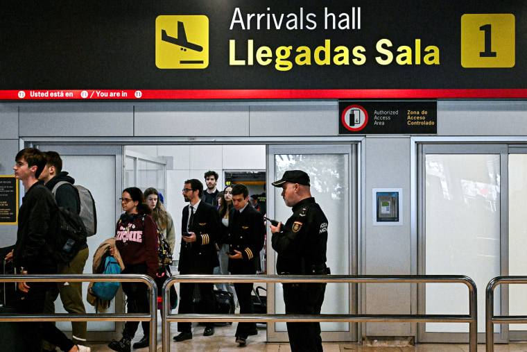 A Spanish national police officer at the arrivals hall of the Madrid Barajas airport.
