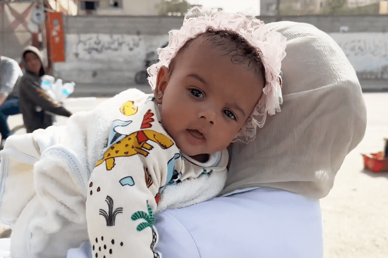 Baby Malak was found in a tree after a strike killed her family. 