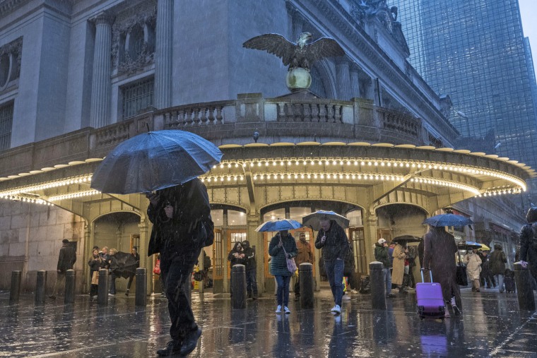 People with umbrellas during heavy rain in New York on April 3, 2024. 
