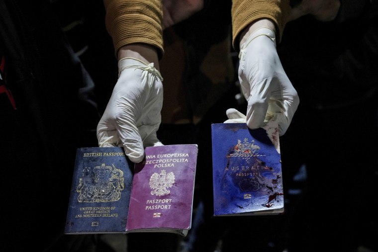 A man displays blood-stained British, Polish, and Australian passports after an Israeli airstrike in Deir al-Balah, Gaza, on April 1, 2024, killed seven World Central Kitchen workers.