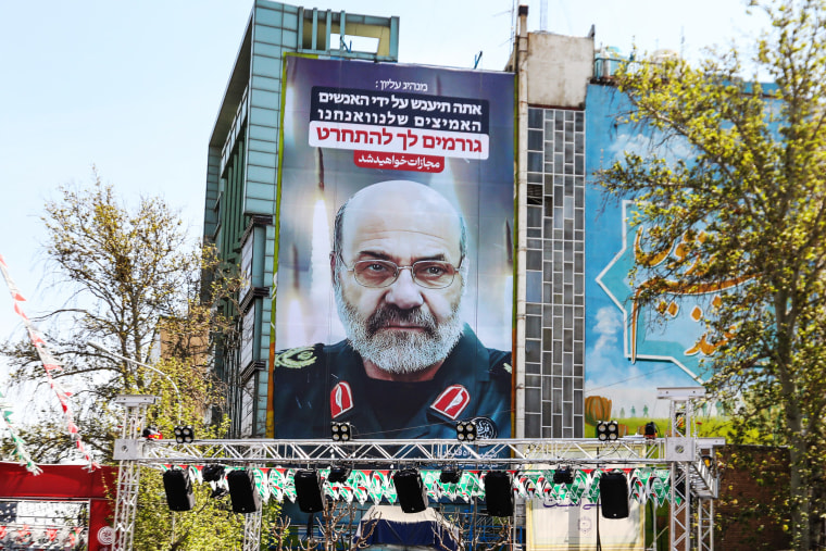 Iran's slain Brigadier General Mohammad Reza Zahedi appears on a billboard on April 3, 2024 in Palestine Square in Tehran. A slogan in Hebrew reads, "You will be punished."