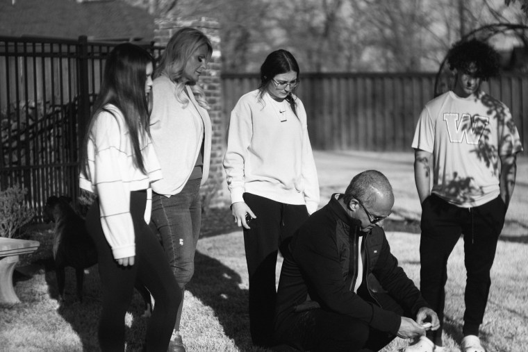 Mason's friend Maggie Stone; his mother, Jennie DeSerio; his friend Haylee Haynes; his stepfather, Dave; and his stepbrother, Anthony, gather at Mason's memorial garden at home in Centerton, Ark.