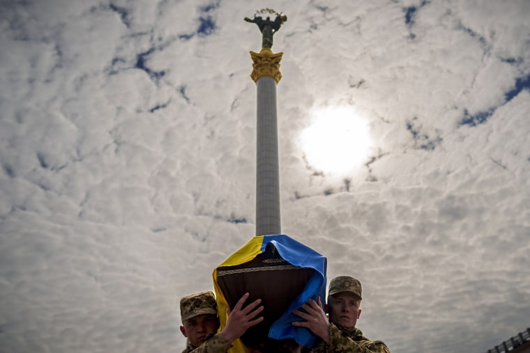 Ukrainian soldiers carry the coffin of a fallen comrade during a service in Independence Square in Kyiv on April 5, 2024. 