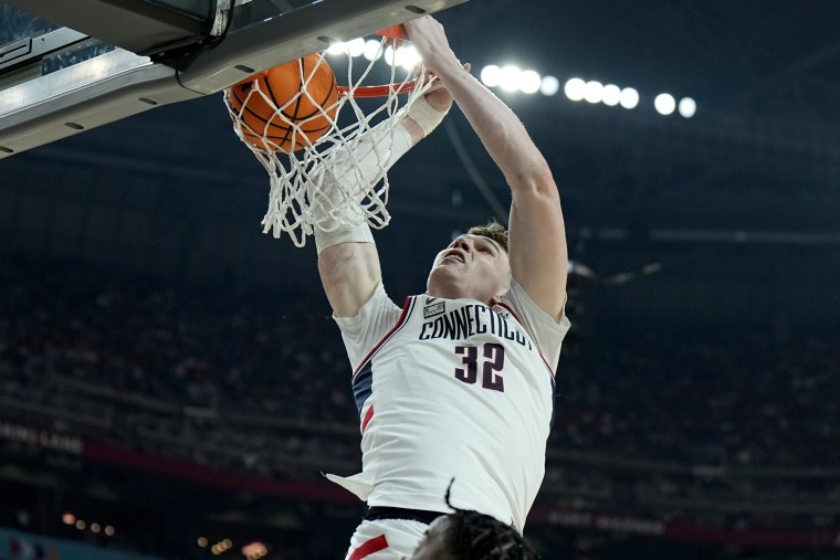 UConn center Donovan Clingan  dunks against Alabama during the first half of the Final Four game Saturday, April 6, 2024, in Glendale, Ariz. against Alabama.  