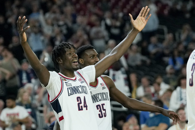 UConn center Youssouf Singare (24) and forward Samson Johnson (35) celebrate after after their win against Alabama in a NCAA college basketball game at the Final Four, Saturday, April 6, 2024, in Glendale, Ariz. (AP Photo/David J. Phillip)